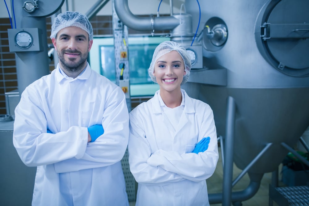 Food technicians smiling at camera in a food processing plant-3